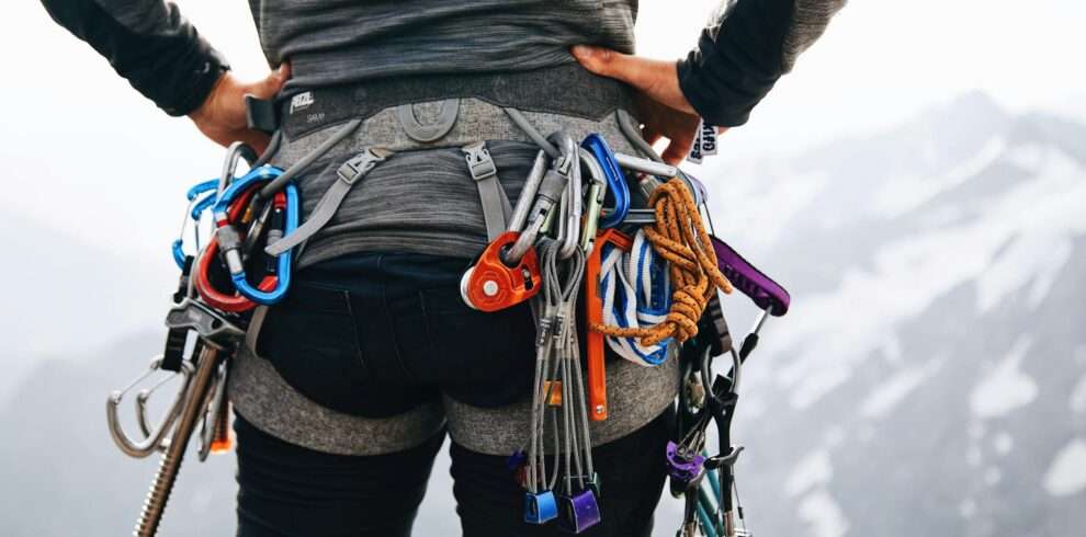 free photo of a person with a backpack and climbing gear on top of a mountain